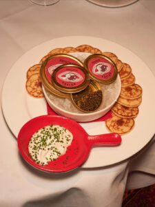 Tins of BISOUS Perle Imperial caviar on ice, with blinis and chive crème fraîche at BISOUS in Amsterdam