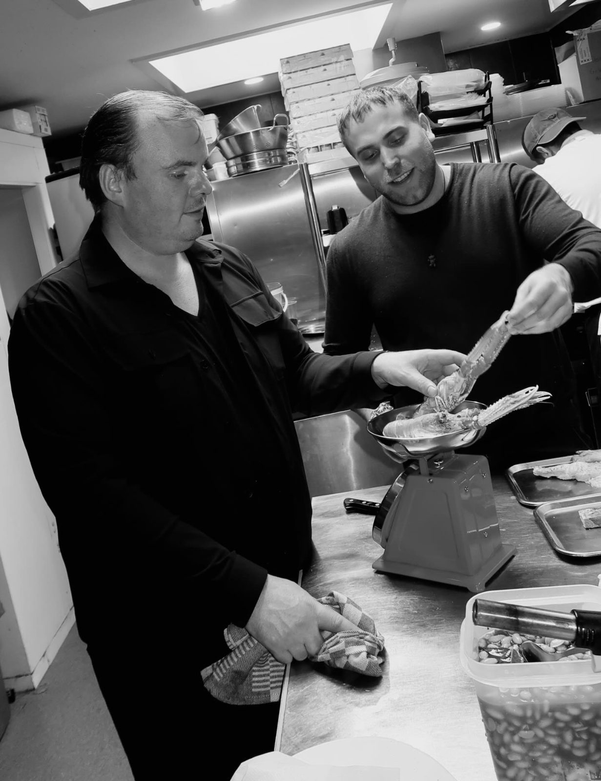 Chefs working at the pass in the kitchen of BISOUS in De Pijp, Amsterdam