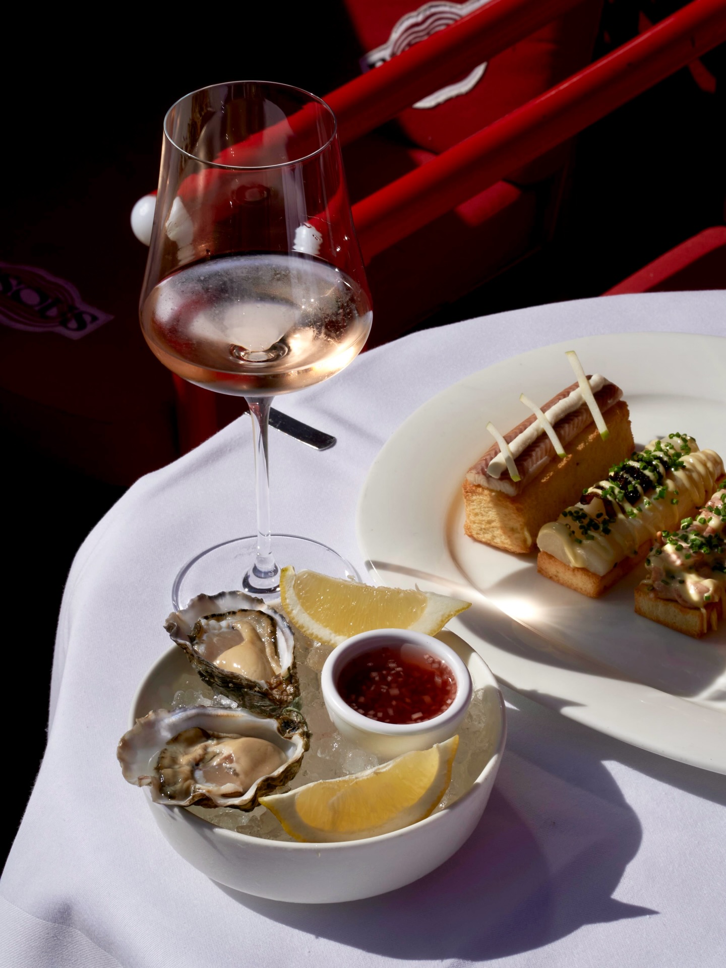 Oysters with mignonette and lemon, toasts and a glass of wine at BISOUS in De Pijp, Amsterdam