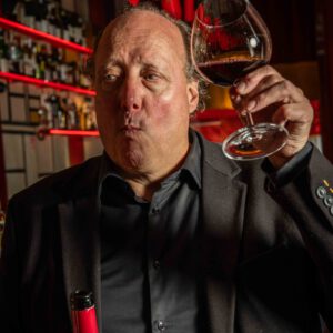 Sommelier Erwin of BISOUS tasting a glass of red wine at the bar